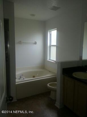 3493 White Wing Road Orange Park, FL 32073 - Photo 14 of 27 a bathroom with a toilet a sink and bathtub