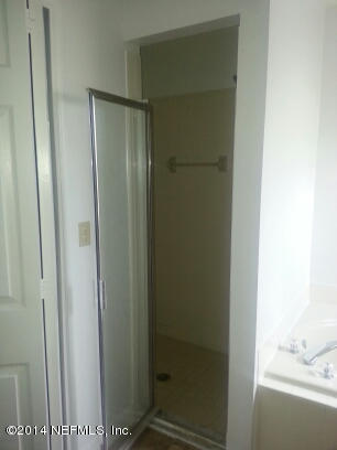 3493 White Wing Road Orange Park, FL 32073 - Photo 15 of 27 a bathroom with a glass shower door