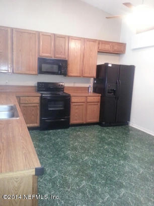 3493 White Wing Road Orange Park, FL 32073 - Photo 6 of 27 a kitchen with granite countertop a refrigerator and a stove
