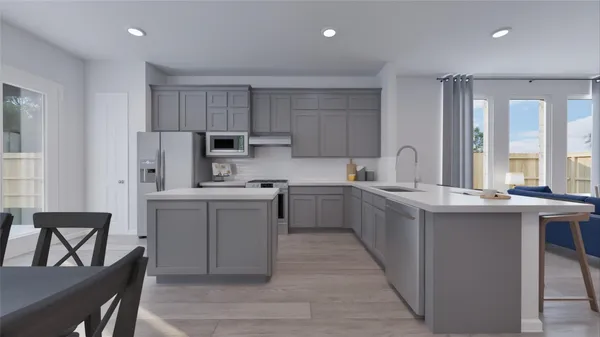 a kitchen with stainless steel appliances granite countertop a refrigerator a stove top oven a sink and a island