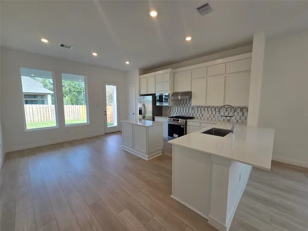 a kitchen that has a sink and a stove in it
