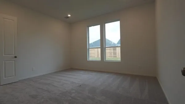 a bedroom with a bed table and a window