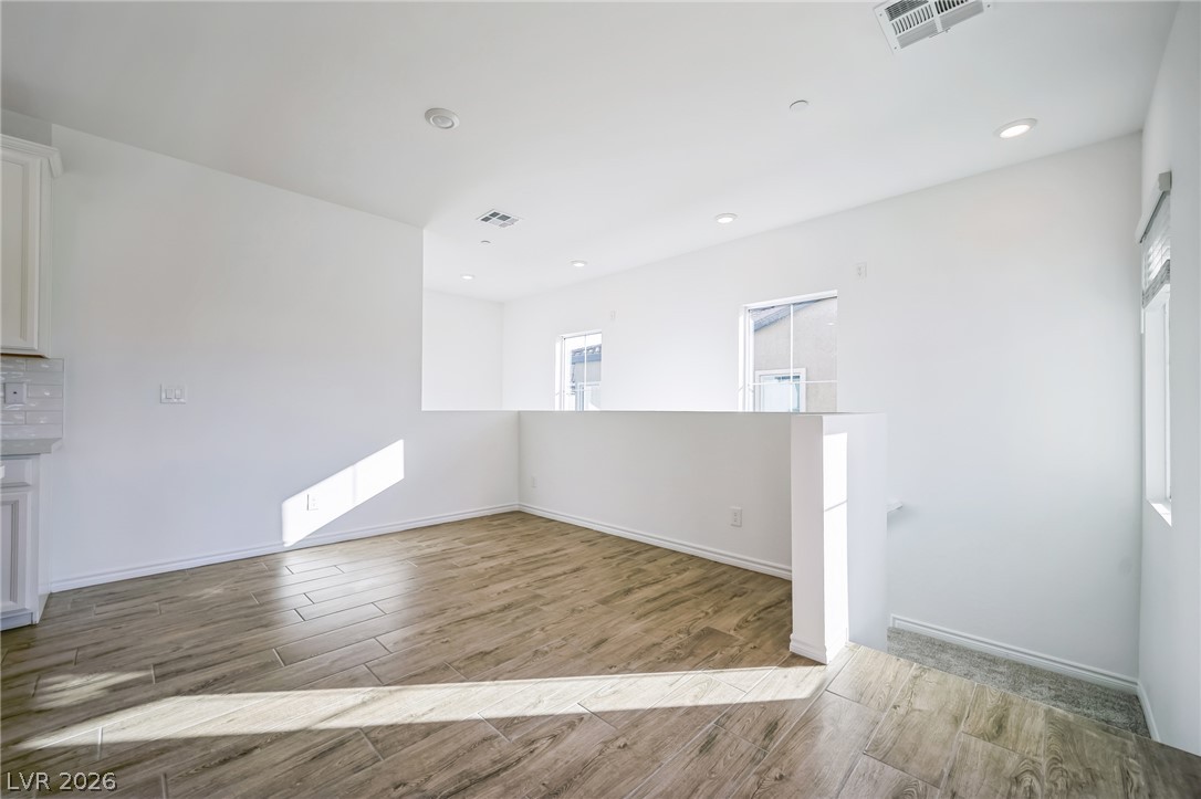 7348 North Decatur Boulevard, Unit 1 North Las Vegas, NV 89084 - Photo 9 of 17 The open-concept layout features rich wood-look tile flooring and abundant natural light.