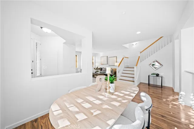 a dining room with furniture and wooden floor