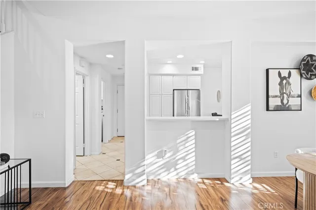 a view of a bedroom with wooden floor and a bathroom
