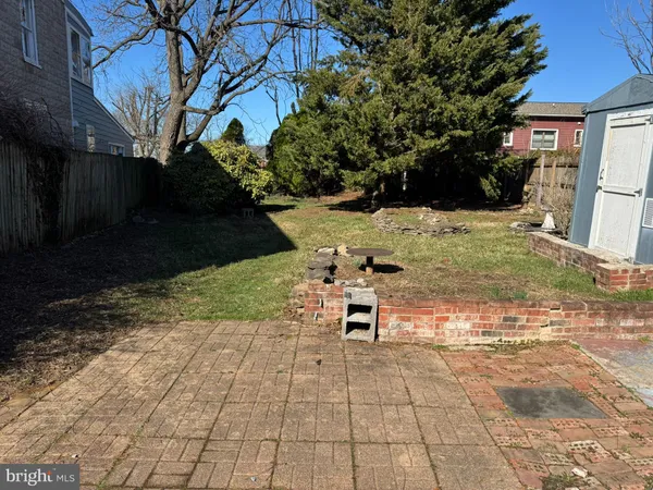 a view of a backyard with sitting area