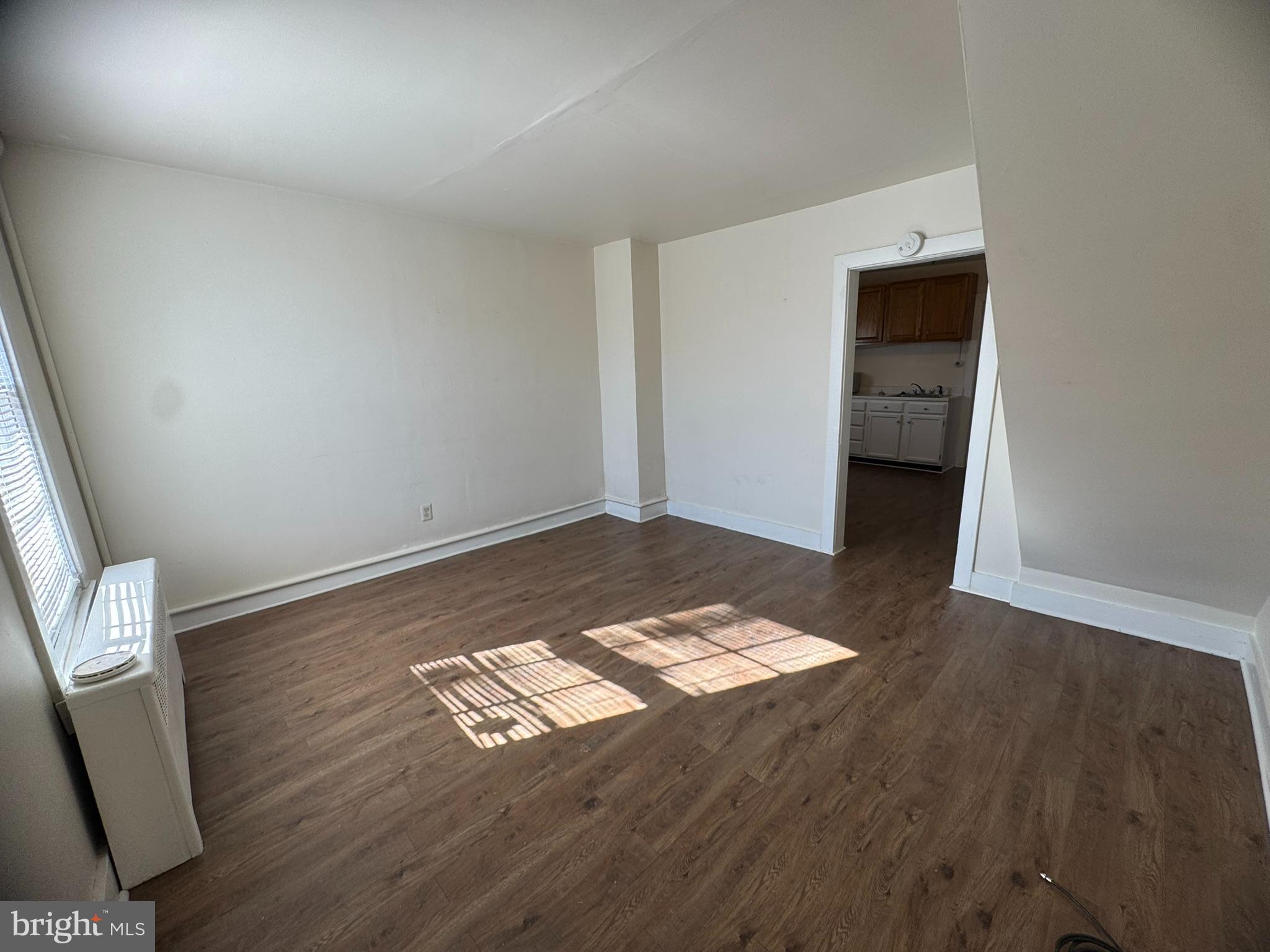 125 South Bentz Street Frederick, MD 21701 - Photo 3 of 16 an empty room with wooden floor and natural light
