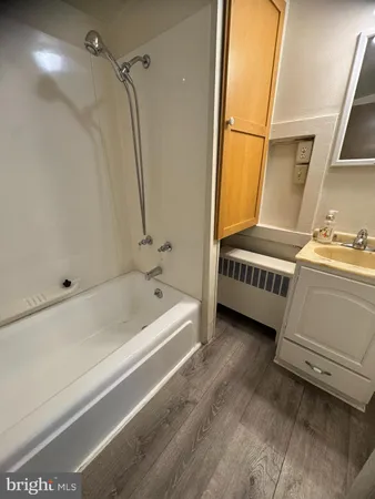 a bathroom with a sink a bathtub and a shower