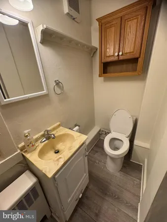 a bathroom with a sink a toilet and mirror