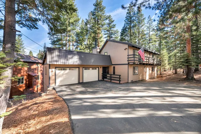 a view of a house with a patio and a yard