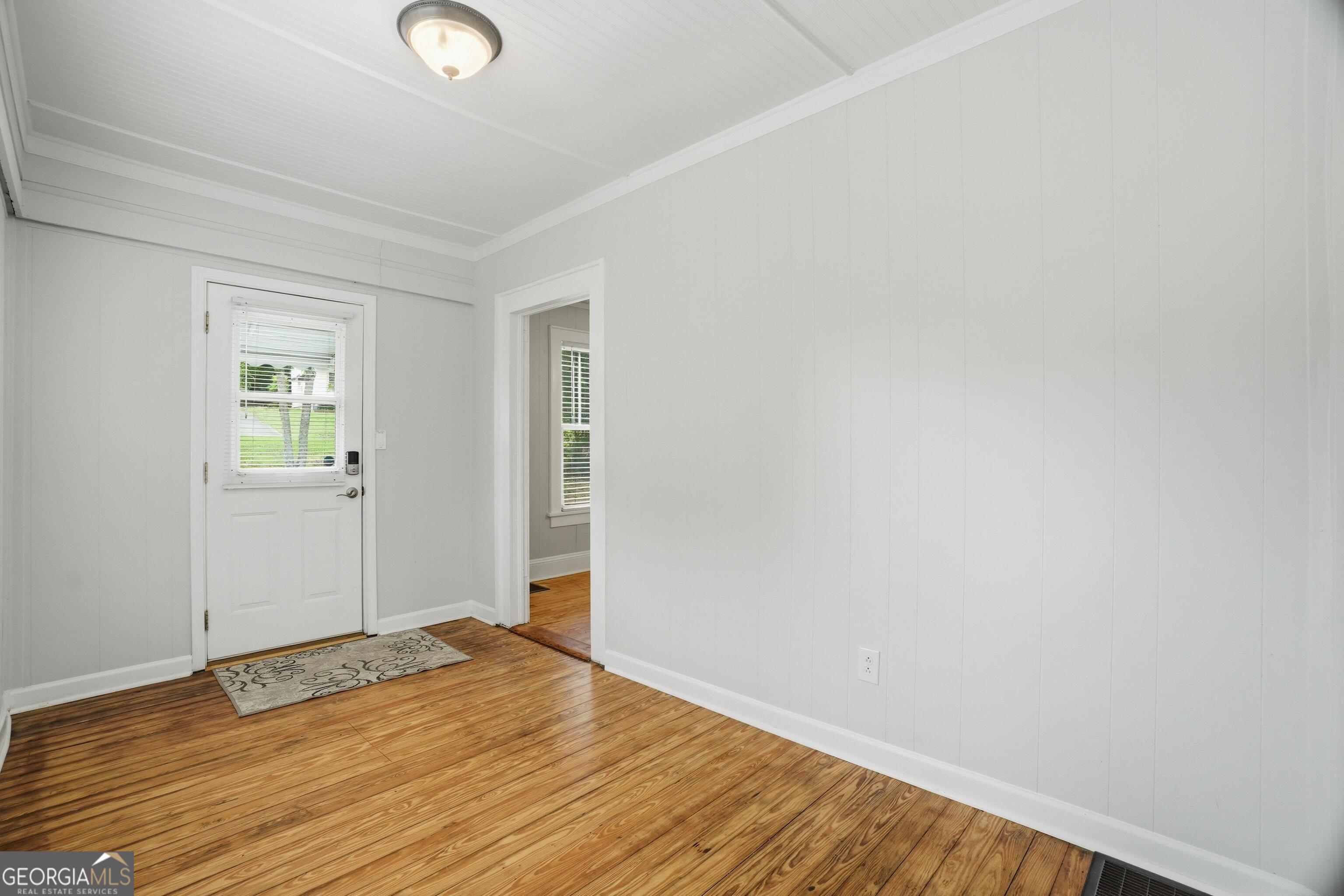 3022 Maple Road Southeast Lindale, GA 30147 - Photo 2 of 29 an empty room with wooden floor and windows