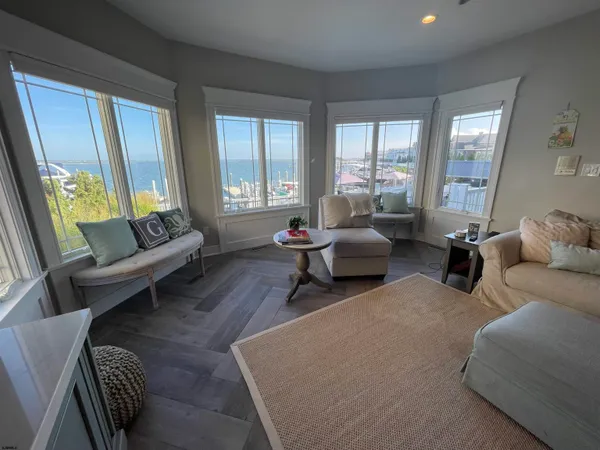a kitchen with lots of wooden furniture table and chairs