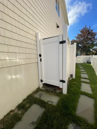 a front view of a house with a garden and mountain view