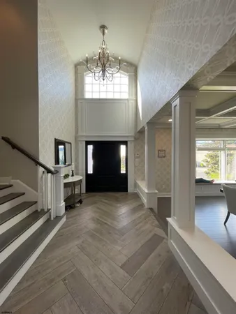 a spacious bedroom with a bed a couch and large window