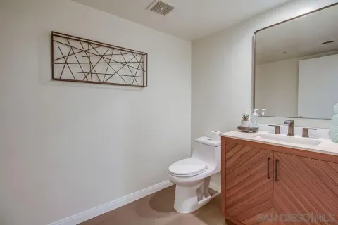 a white toilet sitting next to a bathroom sink