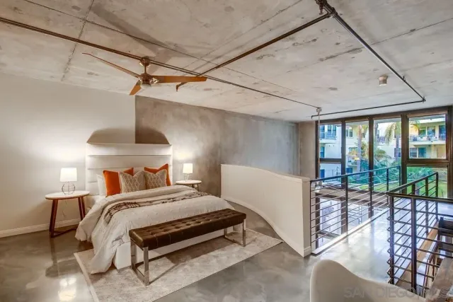 a bedroom with a bed and large window