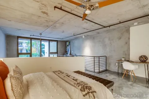 a bed sitting in a bedroom next to a window