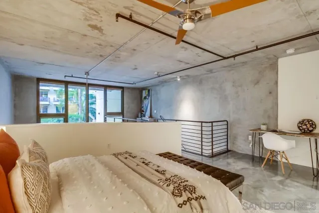 a bed sitting in a bedroom next to a window