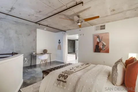 a bedroom with a bed and a chair