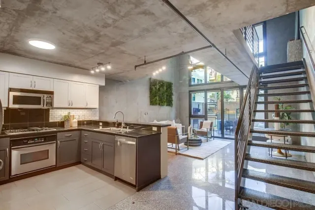 a kitchen with lots of counter top space and wooden floor