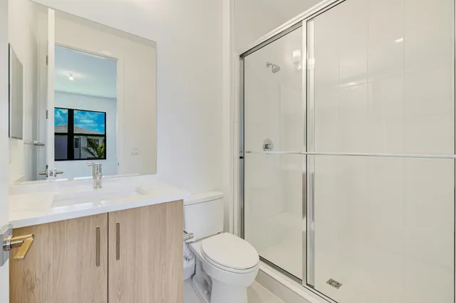 a view of a house with a yard and potted plants
