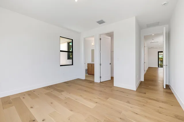 a picture of a city with lots of residential buildings ocean and mountain view in back