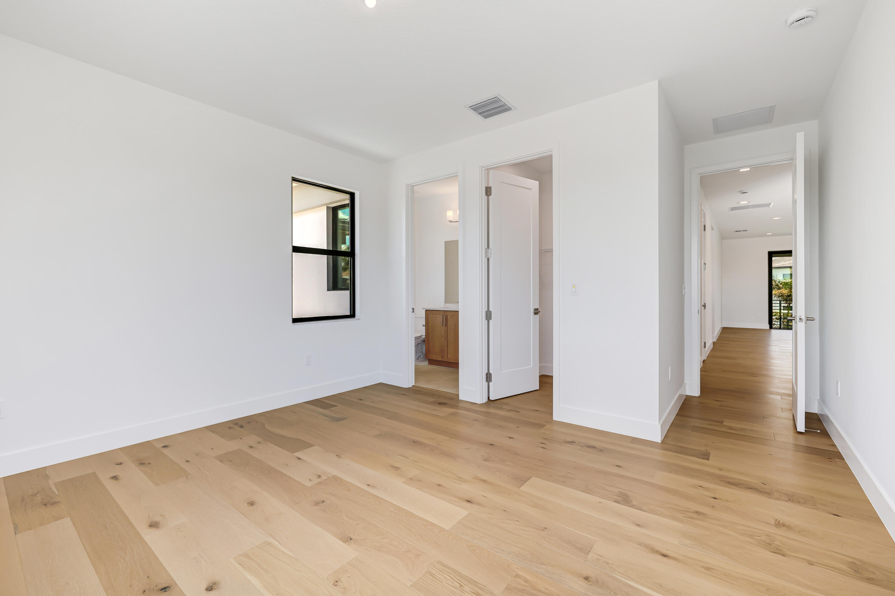 9451 Riverside Pk Drive Boca Raton, FL 33434 - Photo 43 of 71 a view of an empty room with wooden floor and a window