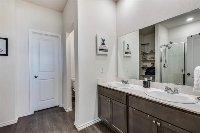 a bathroom with double vanity sinks and a mirror