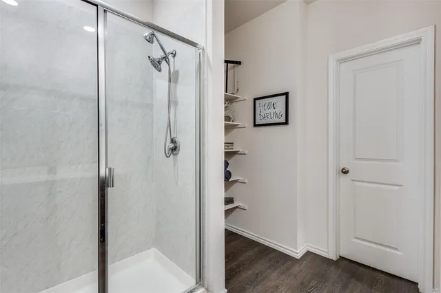 a bathroom with a shower and a glass door