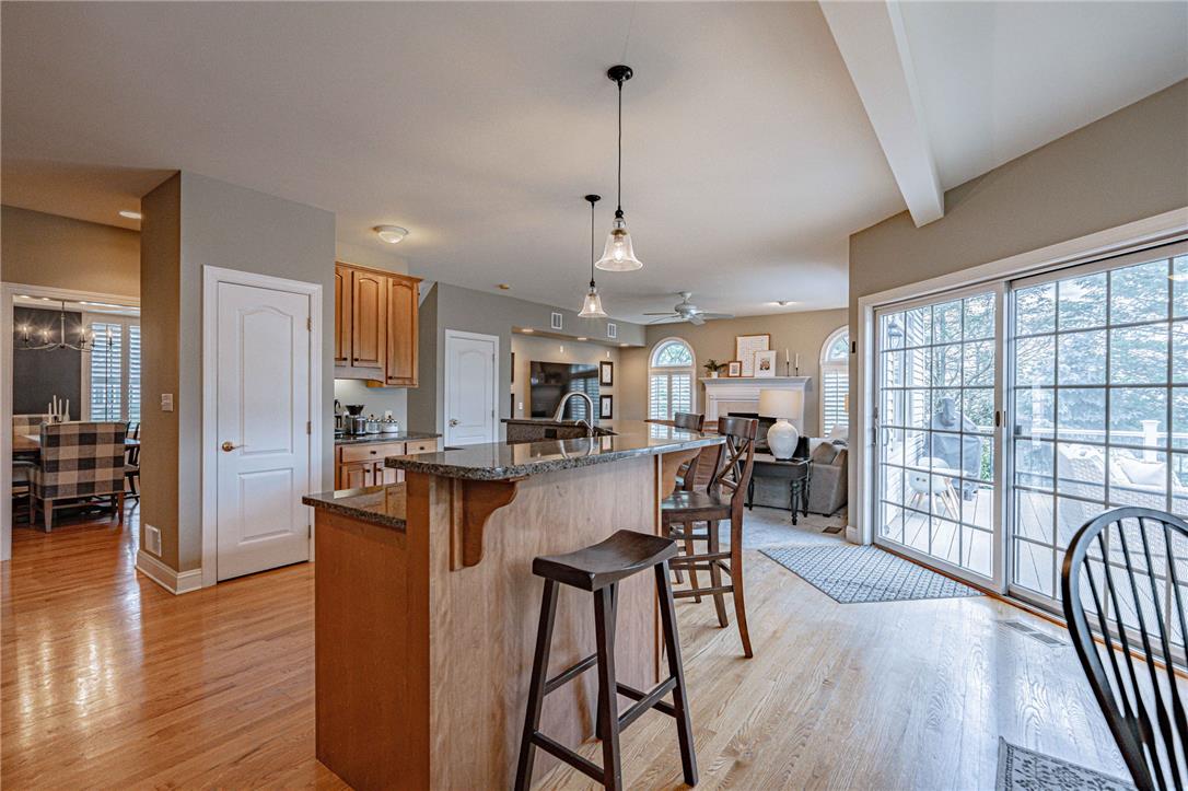6000 Pond View Terrace Bath, PA 18014 - Photo 27 of 69 An inviting open-concept kitchen and living area, complete with a breakfast bar, offers access to the deck, through expansive sliding glass doors.