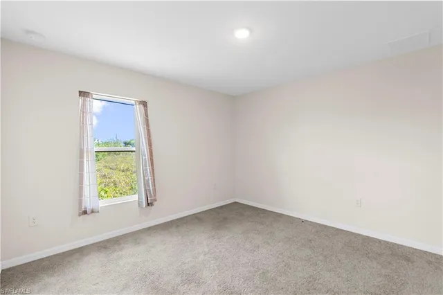 a kitchen with a sink cabinets and wooden floor