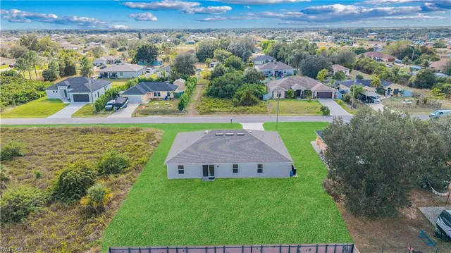 an aerial view of a house with a yard