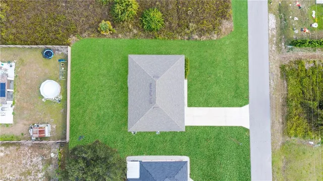 a view of an house with backyard space and garden