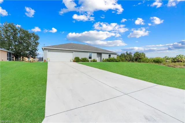 a view of a house with backyard and garden