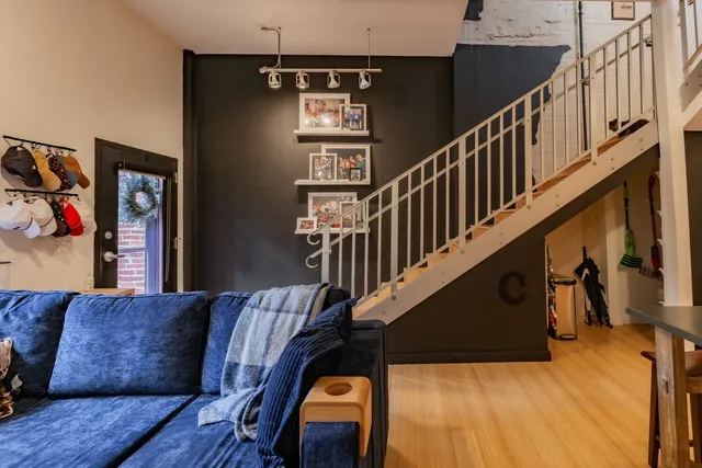 a view of entryway and hall with wooden floor