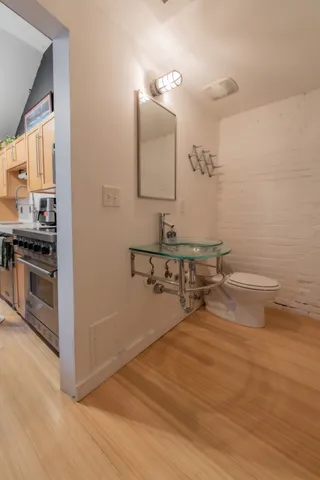 a bathroom with a sink a toilet and mirror