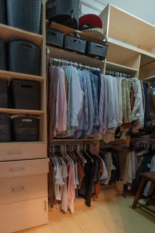 a view of walk in closet with clothes