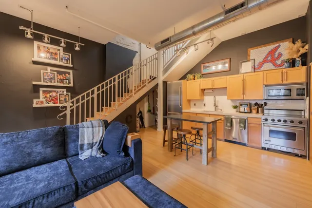 a view of a living room and dining room with furniture