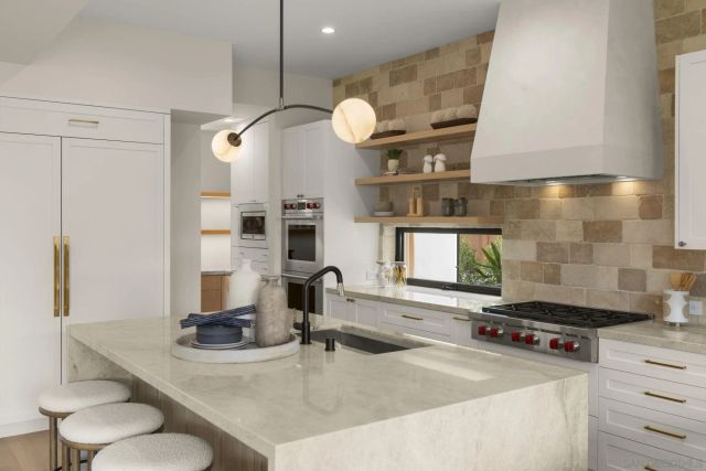 a living room with furniture a fireplace and a clock