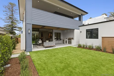 a outdoor living space with furniture potted plant and a fireplace