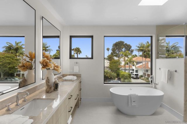 a bathroom with a granite countertop double vanity sink mirror and toilet