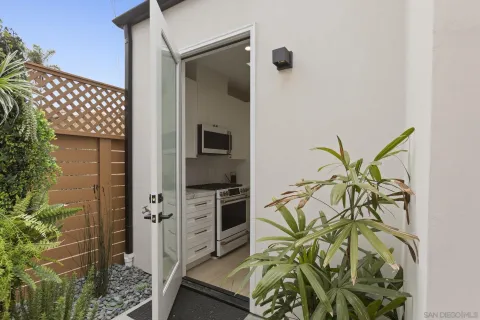 a kitchen with stainless steel appliances granite countertop a refrigerator sink and microwave