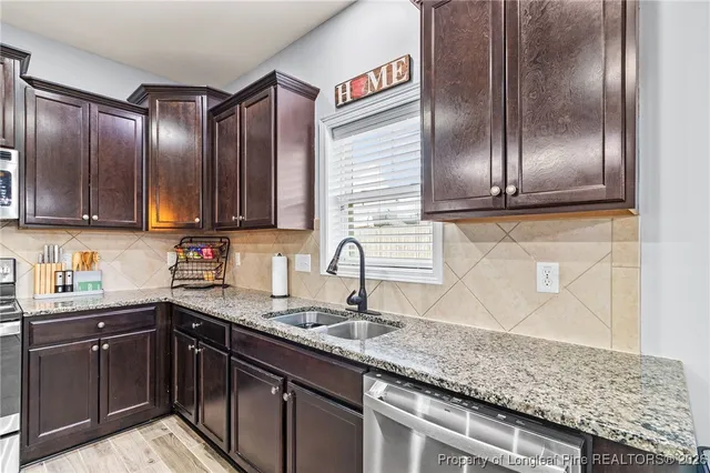 a kitchen with stainless steel appliances granite countertop cabinets and granite counter tops