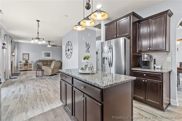 a kitchen with sink refrigerator and cabinets