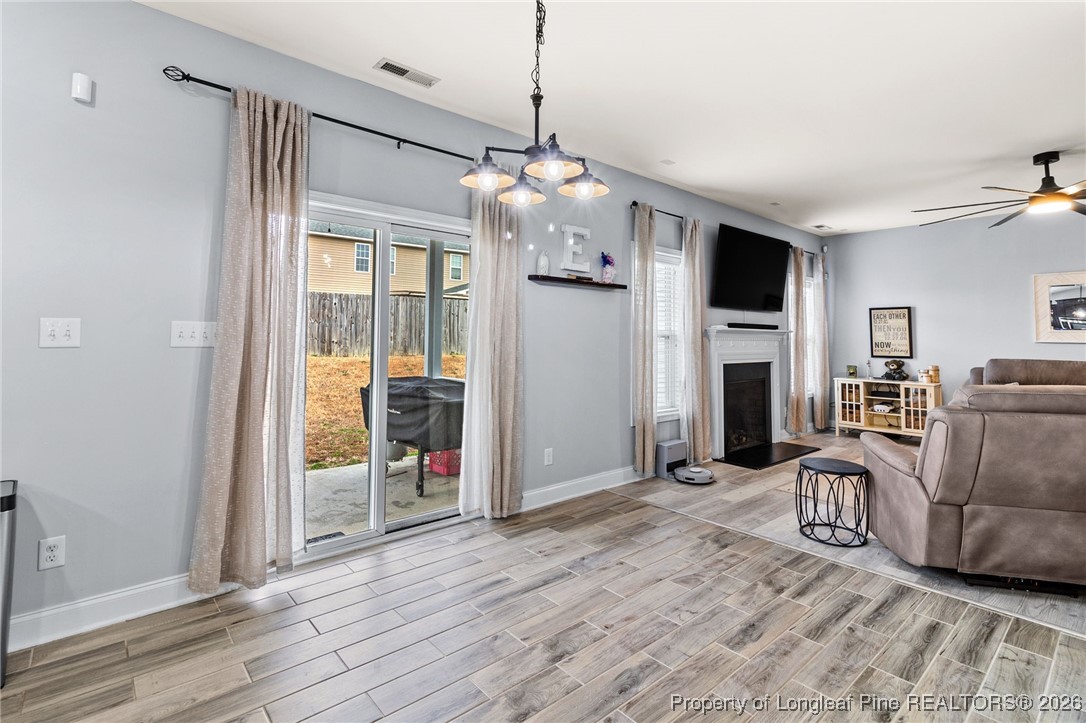 121 Colonist Place Cameron, NC 28326 - Photo 18 of 46 a living room with furniture a flat screen tv and a chandelier