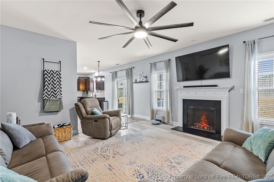 121 Colonist Place Cameron, NC 28326 - Photo 21 of 46 a living room with furniture a flat screen tv and a fireplace