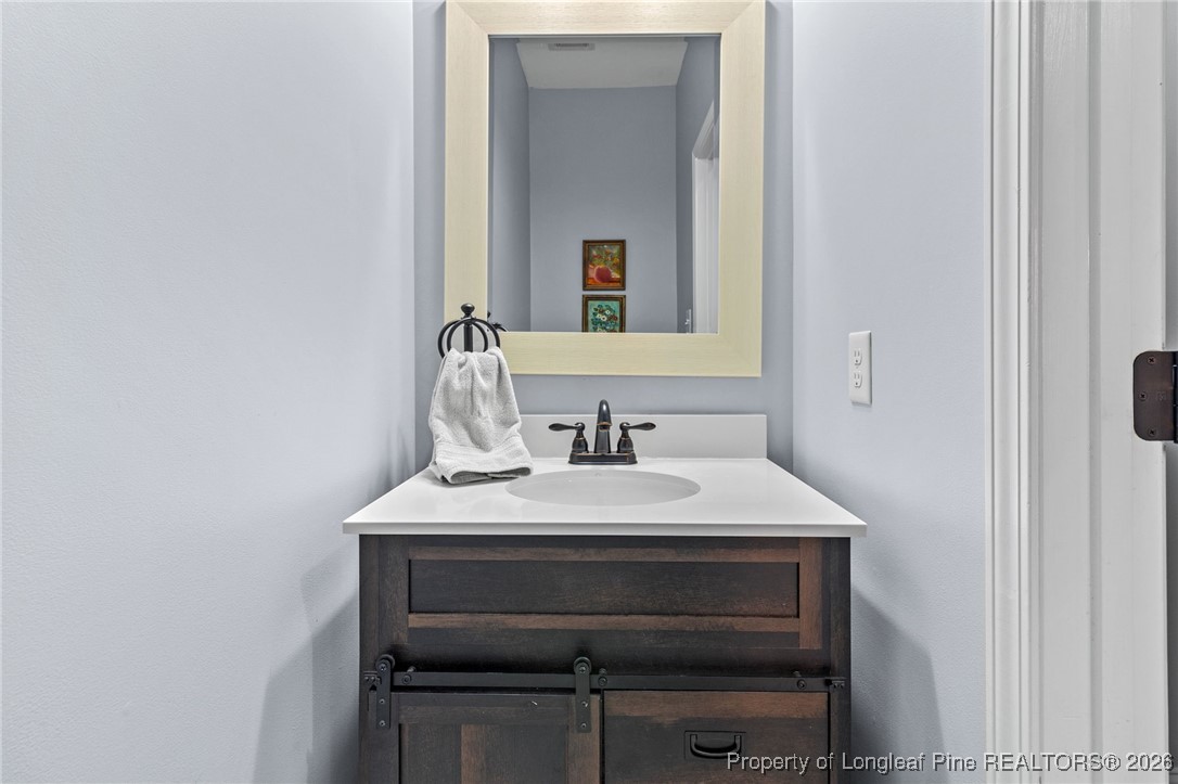 121 Colonist Place Cameron, NC 28326 - Photo 23 of 46 a bathroom with a sink and a mirror