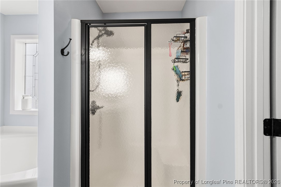 121 Colonist Place Cameron, NC 28326 - Photo 30 of 46 a bathroom with a glass shower door