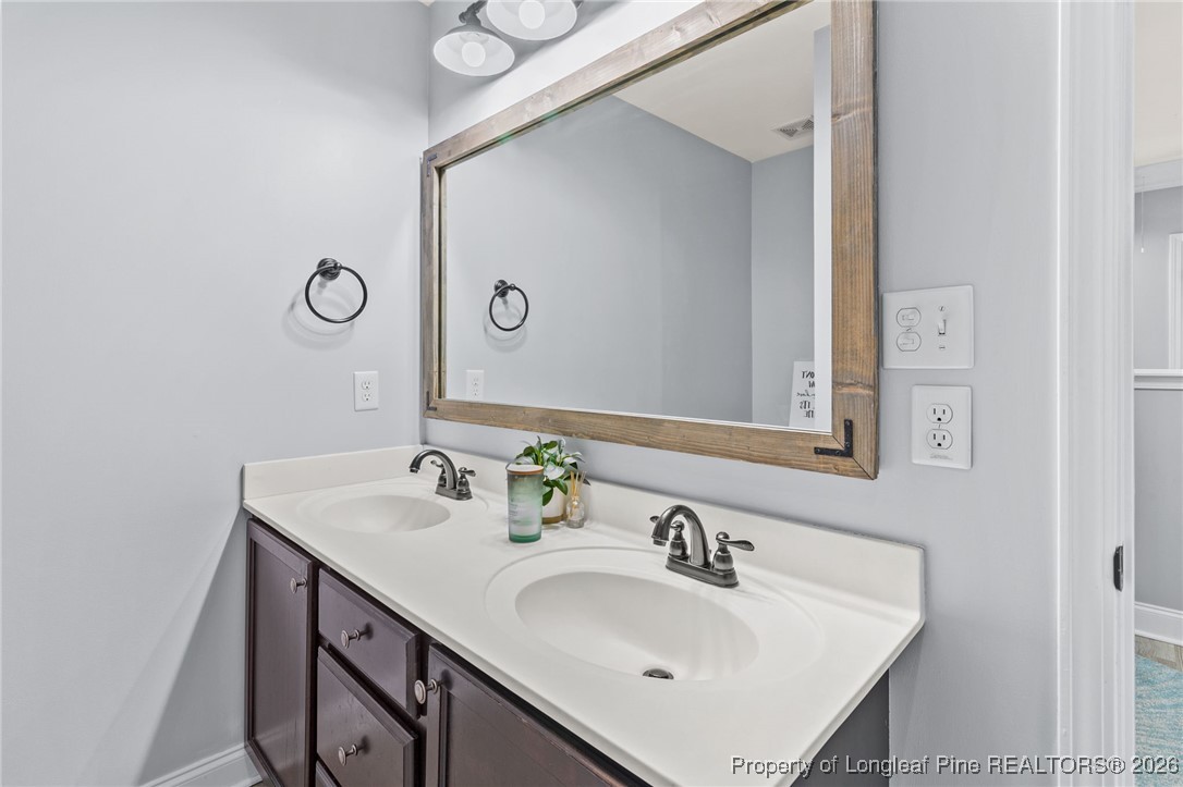 121 Colonist Place Cameron, NC 28326 - Photo 35 of 46 a bathroom with a sink and a mirror