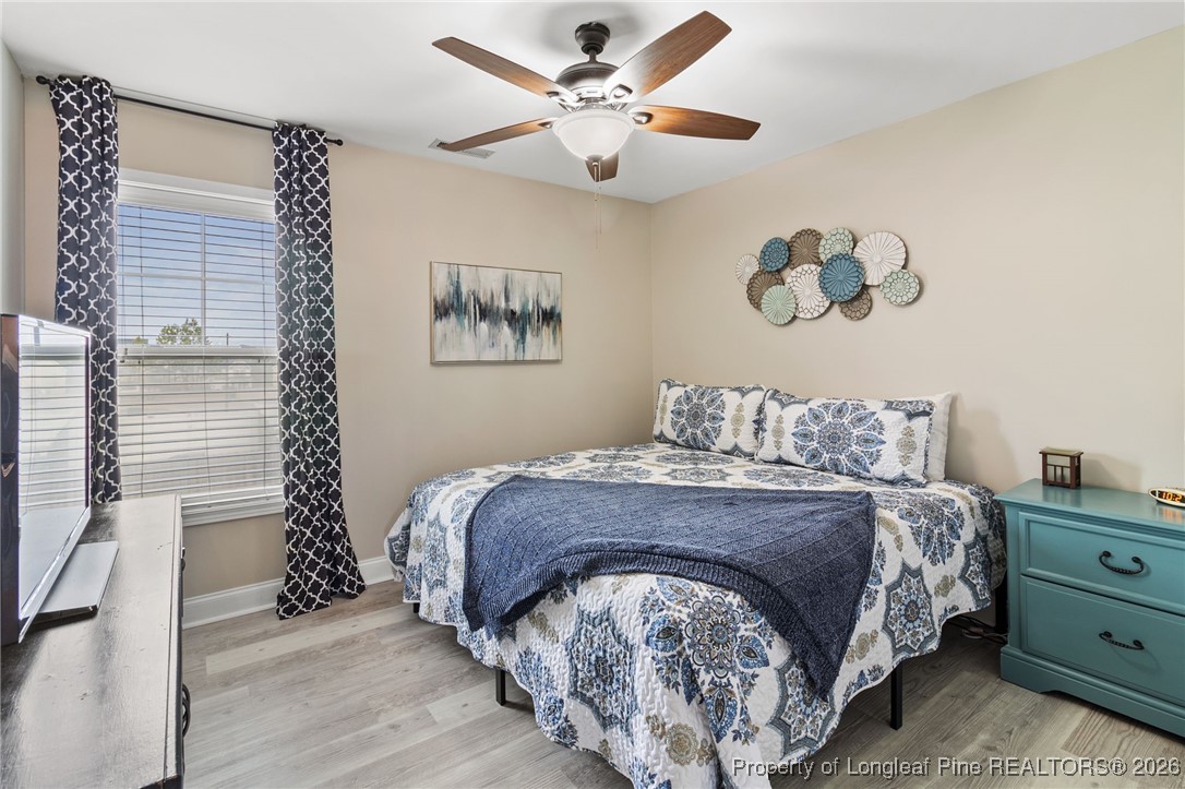 121 Colonist Place Cameron, NC 28326 - Photo 38 of 46 a bedroom with a bed and a chandelier